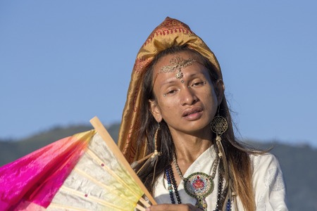 Shemale dancing with a fan at sunrise in Pokhara, Nepal.の写真素材
