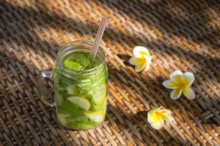 Lemon fruit Caipirinha alcoholic beverage of Brazil in glass mug on wooden table, close upの写真素材