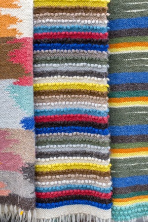 Traditional beautiful colored woolen blankets on the street market in the Carpathians, Ukraine. Close upの写真素材