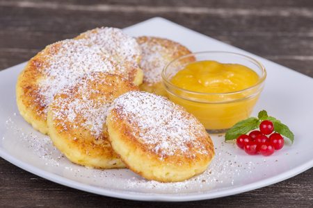 Delicious homemade cottage cheese pancakes with raisin and honey, close upの写真素材