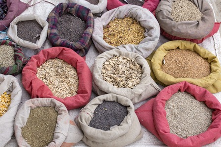 A variety of colorful spices in the Asian market are packed in pouches. Ladakh, Leh, India. Close up, top viewの写真素材