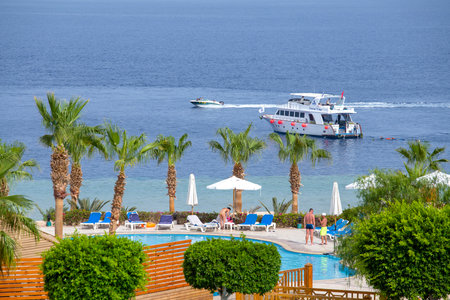 SHARM EL-SHEIKH, EGYPT - MAY 25, 2018: People rest in the swimming pool next to the red sea in the resort hotel in Sharm El Sheikh, South Sinai, Egyptのeditorial素材