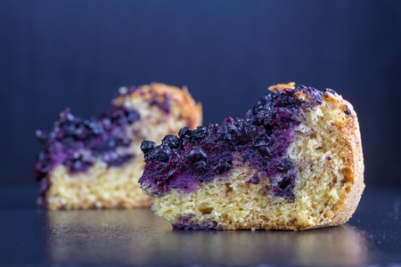 Homemade organic blueberries pie dessert ready to eat, close up. Blueberry tart on black slate backgroundの写真素材