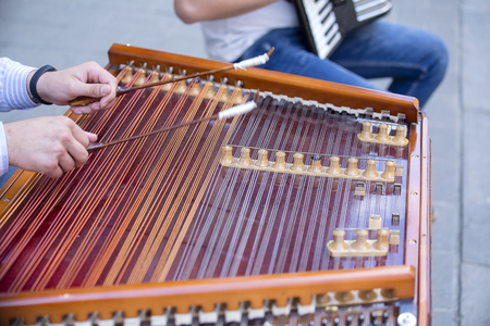 Man hands playing on a harp, the Ukrainian national musical instrument, close up. Lviv, Ukraine