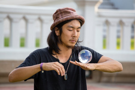 BANGKOK, THAILAND - JANUARY 21, 2015 : Unidentified street performer man juggling glass bowl in front of passers-by on the street Khao San Road in Bangkokのeditorial素材
