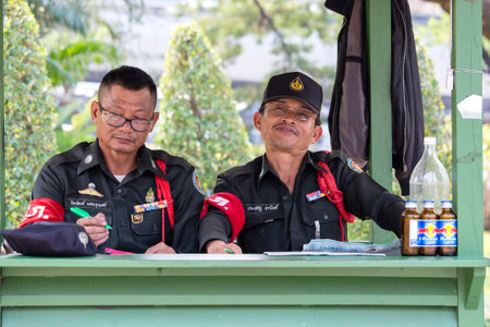 BANGKOK, THAILAND - FEBRUARY 08, 2015 : Thai policemen watching the order in the street in Bangkok,...