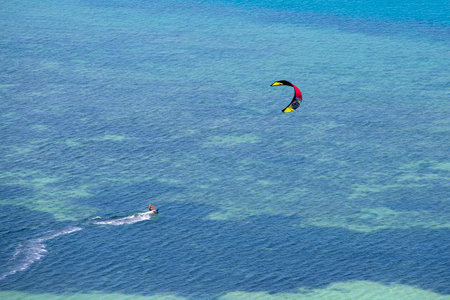 KOH PHANGAN, THAILAND - MARCH 02, 2018 : Young man kitesurfing in ocean, extreme summer sport on the island Koh Phangan, Thailandのeditorial素材