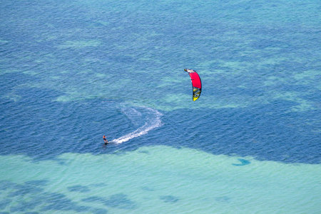 KOH PHANGAN, THAILAND - MARCH 02, 2018 : Young man kitesurfing in ocean, extreme summer sport on the island Koh Phangan, Thailandのeditorial素材