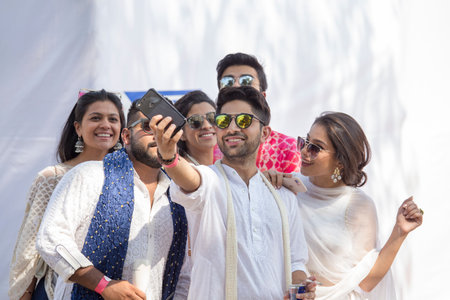 MUMBAI, INDIA - JANUARY 29, 2017 : Unknown Indian youth makes a selfies on a smartphone in the street of the city of Mumbai, Indiaのeditorial素材