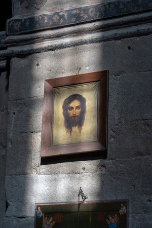 Sunlight from the window on the old icon depicting Jesus Christ in the old orthodox cathedral in historical town Mtskheta near Tbilisi, Georgiaのeditorial素材