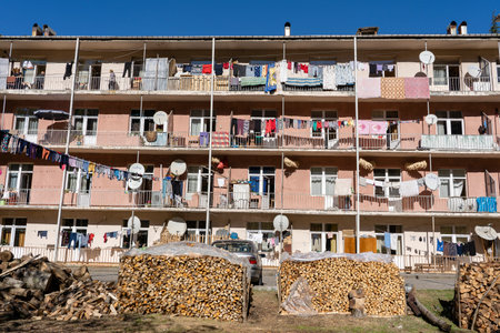 KEDA, GEORGIA - OCTOBER 30, 2018 : Linen is dried on the balcony in a residential building and near the yard are firewood. Small mountain village near the city of Batumi, Georgiaのeditorial素材