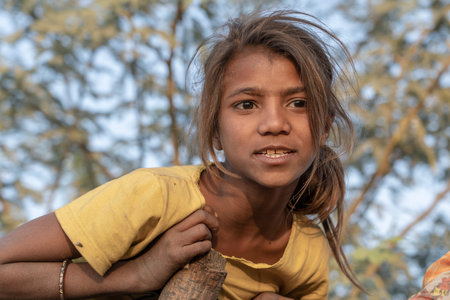 PUSHKAR, INDIA - NOVEMBER 17, 2018 : Indian young girl in the desert Thar on time Pushkar Camel Mela near holy city Pushkar, Rajasthan, India, close up portraitのeditorial素材