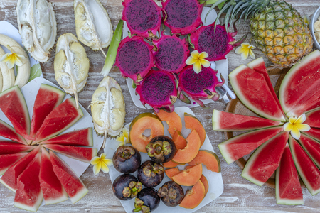 Tropical fruits assortment, close up, top view. Many colorful ripe fruits background. Durian, papaya, watermelon, banana, mangosteen, pineapple and pitahaya or dragon fruit in island Bali, Indonesiaの写真素材