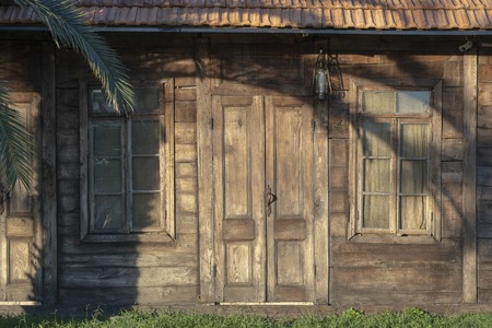 Facade of an old wooden house. Background of the wooden wall of the house, close upの写真素材