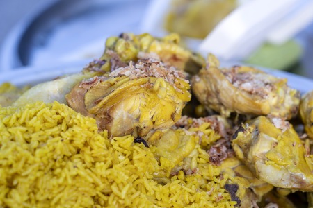Chicken curry with yellow rice for sale in the street market, Thailand, close upの写真素材