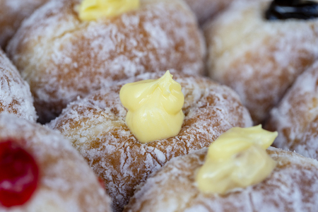 Donuts at street food market in Thailand, close up. Tasty doughnuts with jam, chocolate and condensed milkの写真素材
