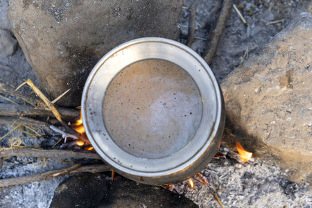 Cooking masala tea on a fire in the Thar desert near the town of Pushkar, Rajasthan India. Close up, top viewの写真素材