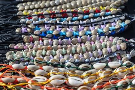 Colorful bracelets for sale on street at night market, Thailand. Souvenirs for tourists at street market , close upの写真素材