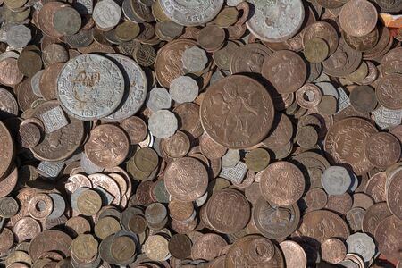 Old vintage fake coins background for sale to tourists in the Indian market on the street in...