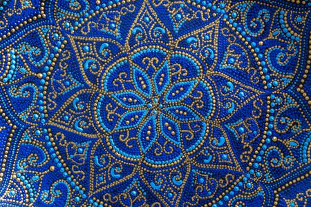 Decorative ceramic plate with blue and golden colors, painted plates, close up. Decorative porcelain plate painted with acrylic paints, handworkの写真素材