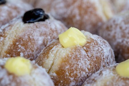 Donuts at street food market in Thailand, close up. Tasty doughnuts with jam, chocolate and condensed milkの写真素材