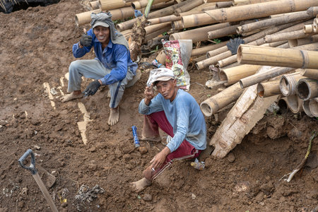 UBUD, BALI, INDONESIA - MARCH 24, 2019 : Two happy indonesian workers rest after earthworks in Ubud, island Bali, Indonesiaのeditorial素材