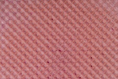Red waffle texture pattern, close up, top view. Pink wafer textured surface backgroundの写真素材