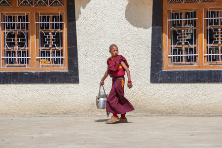 Lamayuru Gompa, Jammu and Kashmir, India - june13, 2015 : Young buddhist monk with colored red clothes during festival at Lamayuru monastry, Ladakh, Indiaのeditorial素材