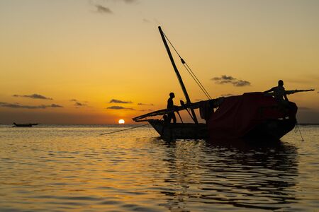 Traditional fisherman dhow boat during sunset on Indian ocean in island Zanzibar, Tanzania, East...