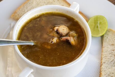 Seafood soup in a white bowl on table, Tanzania, east Africa, close up