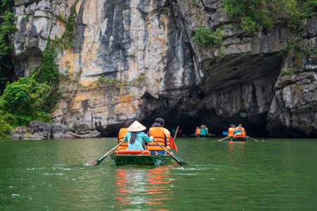 Ninh Binh, Vietnam - march 10, 2020 : Tourist boat trip on Ngo Dong river in Trang An Hang Mua, Vietnam. Beautiful nature of North Vietnam near Hanoiのeditorial素材