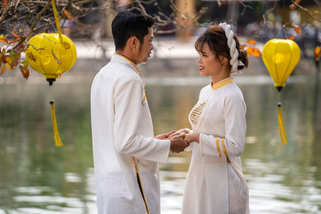 Hoi An, Vietnam - march 15, 2020 : Charming couple of a Vietnamese guy and a girl by the river in the old town in Hoi An, Vietnamのeditorial素材