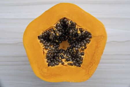 Half of ripe sweet papaya fruit with seeds background, close up, Vietnamの写真素材