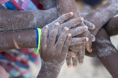 Arm stacked together one by one in unity and teamwork. Many hands getting together in the center of...