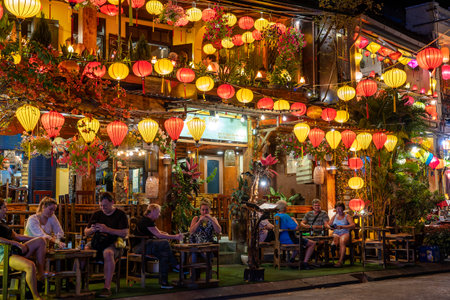 Hoi An, Vietnam - march 15, 2020 : People rest in colorful restaurant near river in Hoi An town. Hoi An is city near Da Nang in middle of Vietnam and famous for its well-preserved old town on riverのeditorial素材