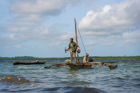 Zanzibar, Tanzania - november 16, 2019 : Traditional fishing sailing boat with african men on Indian ocean in island Zanzibar, Tanzania, East Africaのeditorial素材