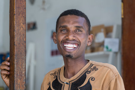Zanzibar, Tanzania - november 23, 2019 : African happy man at a local street food market on the island of Zanzibar, Tanzania, east Africa, close upのeditorial素材