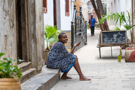 Zanzibar, Tanzania - november 03, 2019 : African girl rest on the street in Stone Town on the island of Zanzibar, Tanzania, East Africaのeditorial素材