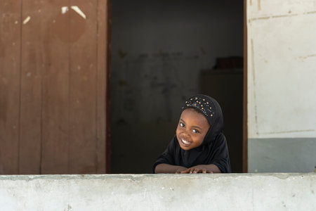 Zanzibar, Tanzania - november 11, 2019 : Unidentified african girl near a local school after class in island Zanzibar, Tanzania, East Africaのeditorial素材