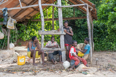 Zanzibar, Tanzania - november 16, 2019 : African men and boys are sitting under a canopy in the shade on the shore of the island of Zanzibar, Tanzania, East Africa, close upのeditorial素材