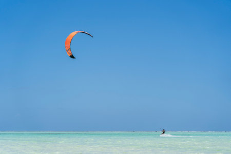 Zanzibar, Tanzania - november 11, 2019 : Kitesurfer rides the waves sea water, attractive sport in sea on Zanzibar island, Tanzania, east Africaのeditorial素材