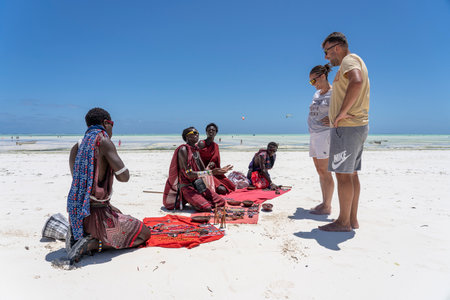Zanzibar, Tanzania - november 11, 2019 : Masai African men sell souvenirs for tourists on the beach near the ocean on the sand beach, island Zanzibar, Tanzania, East Africaのeditorial素材