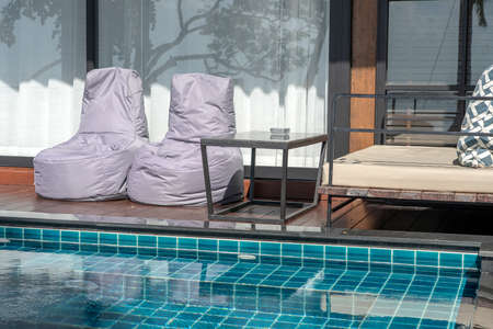 Rest zone near swimming pool in a tropical hotel near summer beach