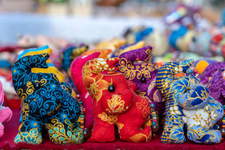 Elephant doll for sell in street market, Thailand. Souvenirs for tourists at market, close upの写真素材