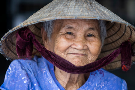 Nha Trang, Vietnam - March 30, 2020: Ethnic old woman with smile on the face on a street market of Nha Trang, Vietnamのeditorial素材