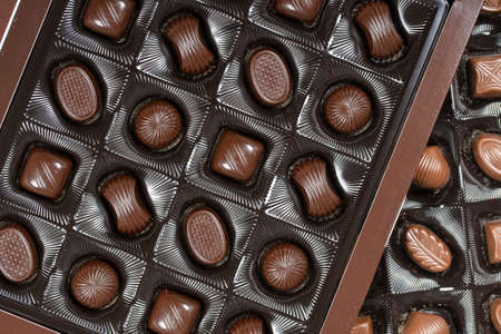 Close up brown chocolate candy background. Assortment of chocolate candies sweets in the boxの写真素材