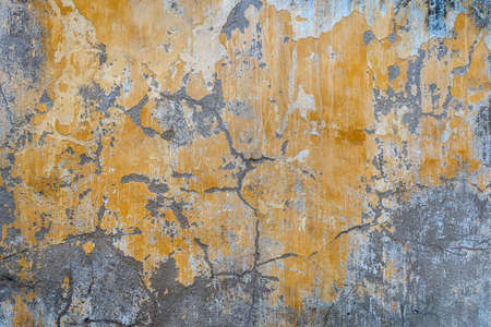 Background of old yellow painted wall, close up texture