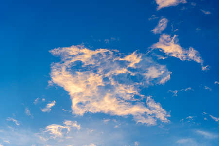 Blue sky background with white clouds during sunset