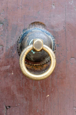 Close up of a ancient traditional wooden door with bronze door knob in Stone Town on island...
