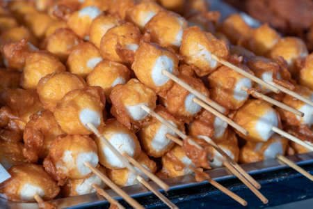 Fried balls in deep fat with sticks, Thai style food. Street fast food in Thailand, close up